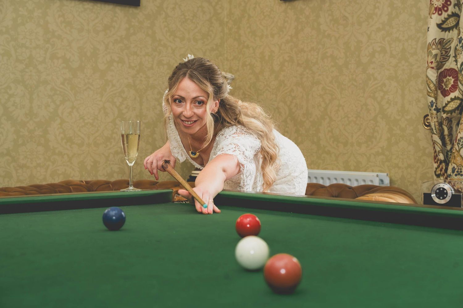 a bride plays pool at her wedding in county durham