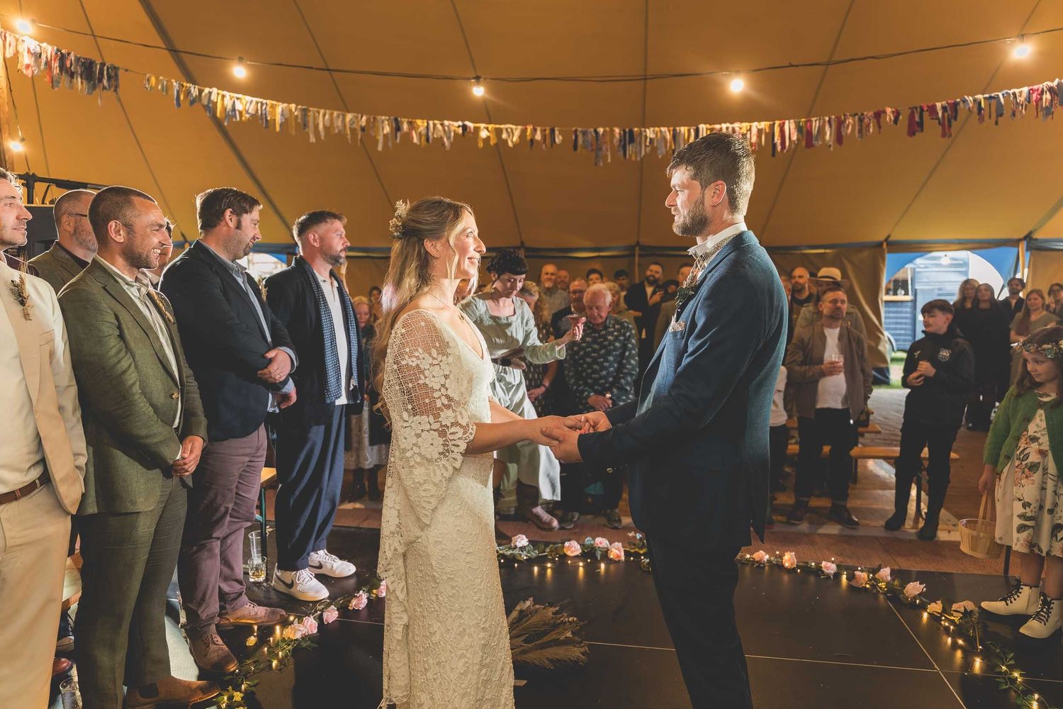 a bride and groom hold hands during their wedding ceremony in Durham