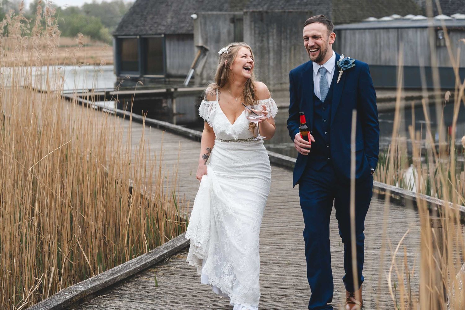 a bride and groom laugh while walking around Brockholes wedding venue near Preston