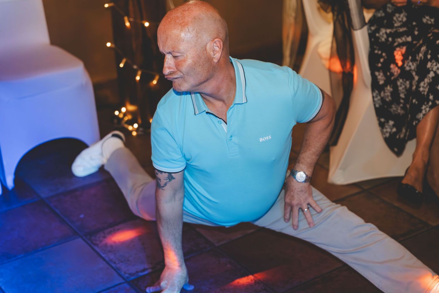 a wedding guest does the splits on the dancelfoor at a wedding in Cheshire