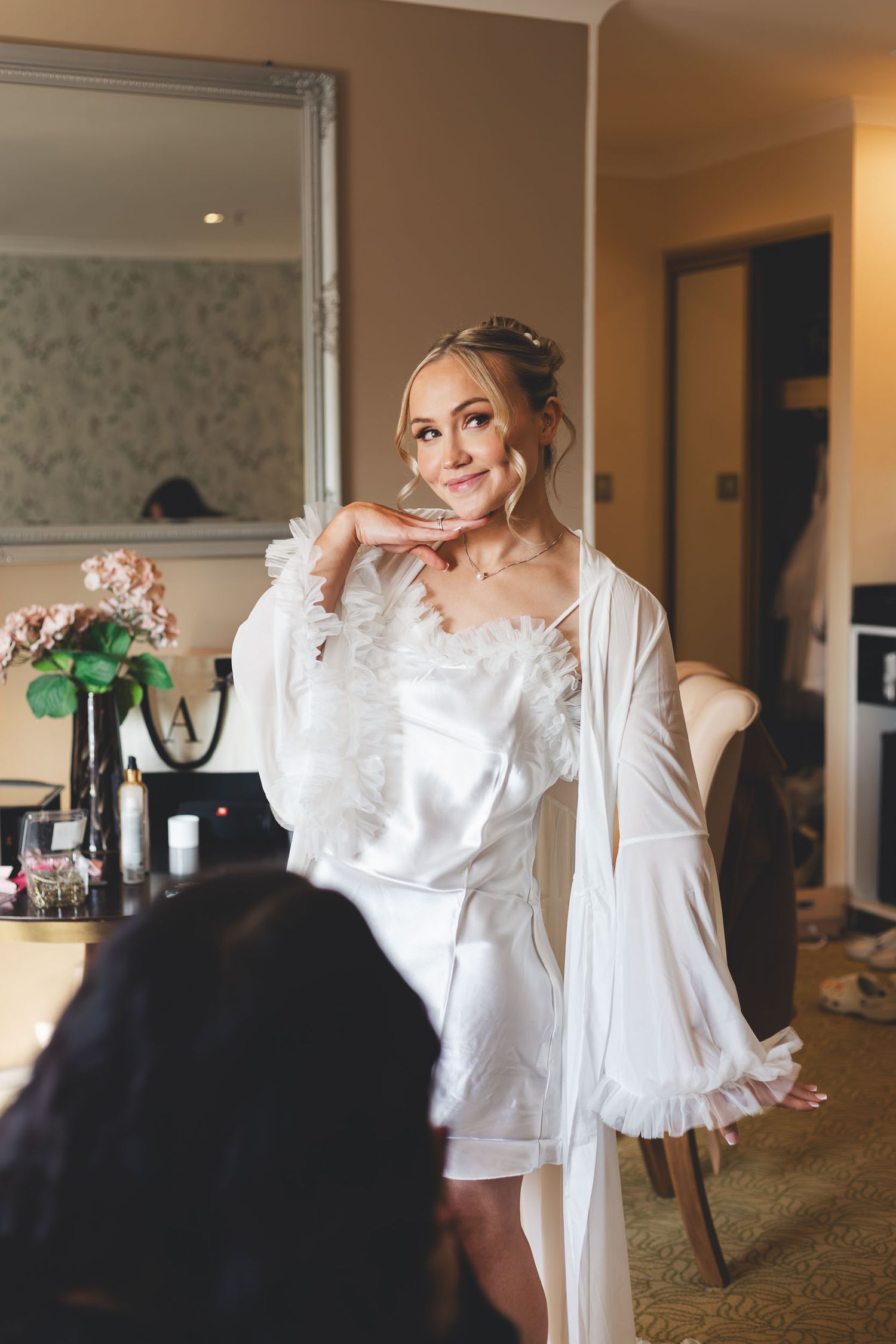 a bride smiles and poses at Hollins Hall wedding venue near Shipley