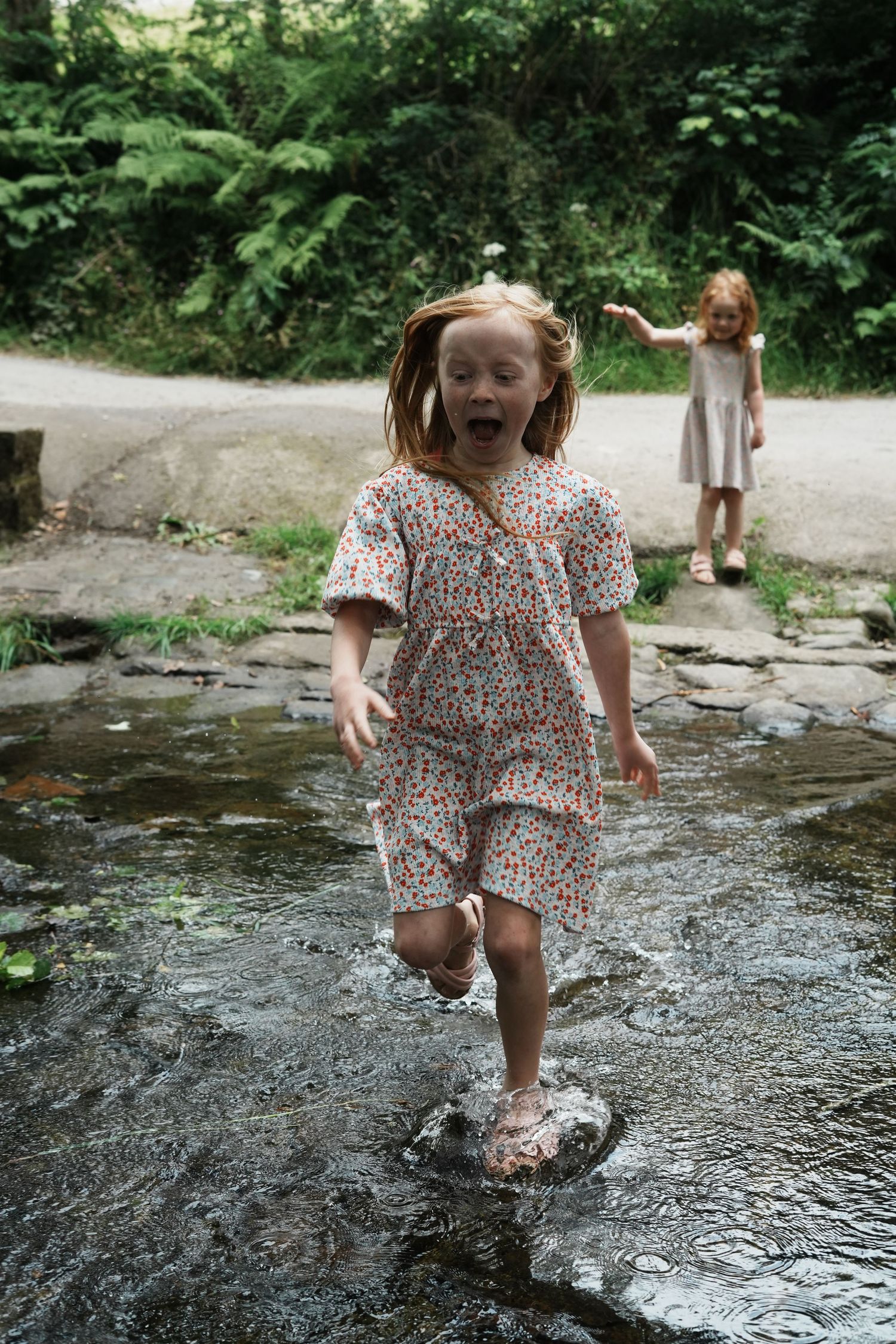 A child laughing as she runs through water in lancashire