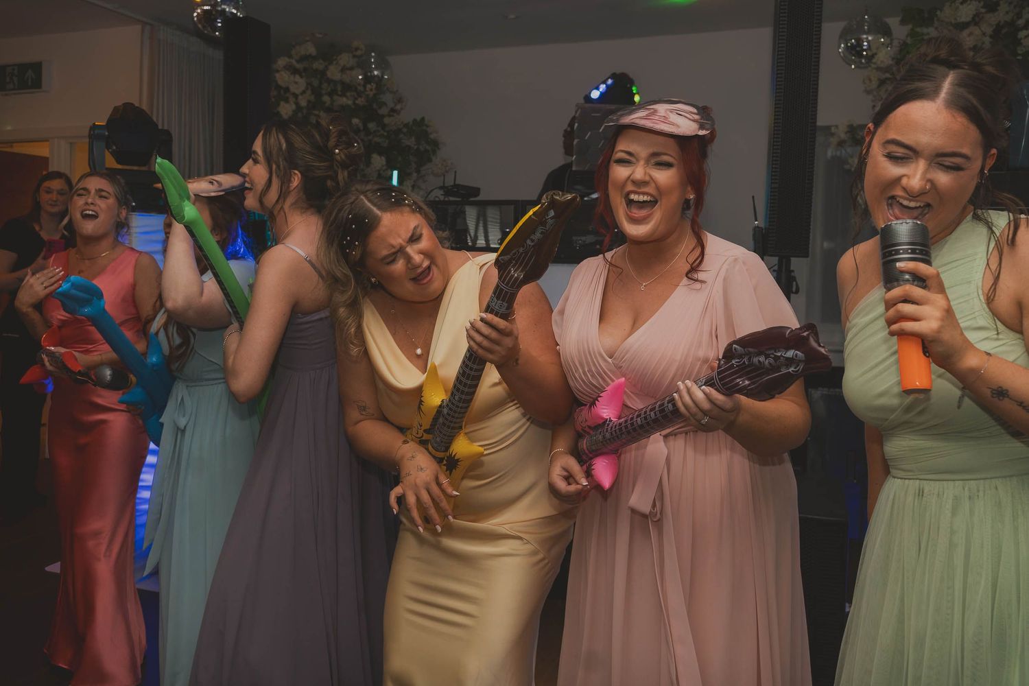 bridesmaids laughing on the dance floor in grater manchester