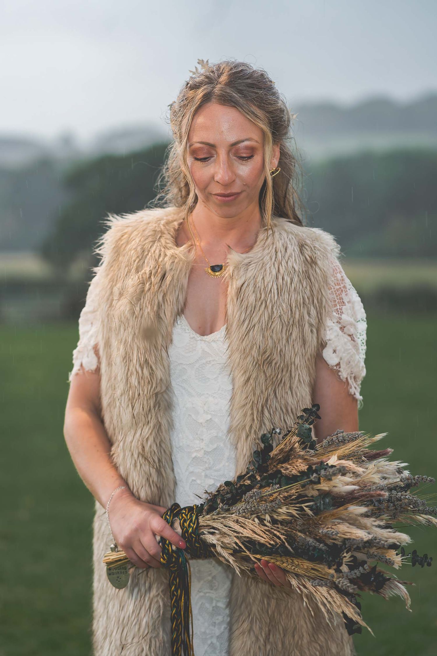 a bride admires her rustic style flowers at a wedding in county durham
