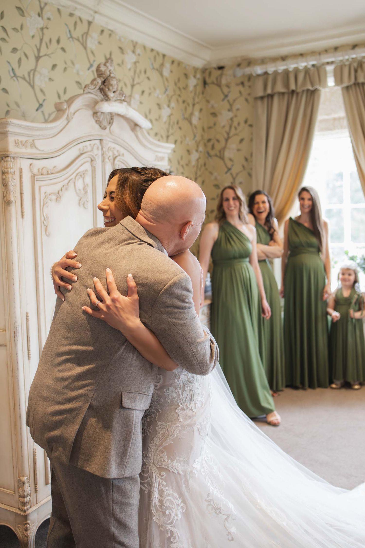 a bride embraces her father in a candid moment in ribble valley