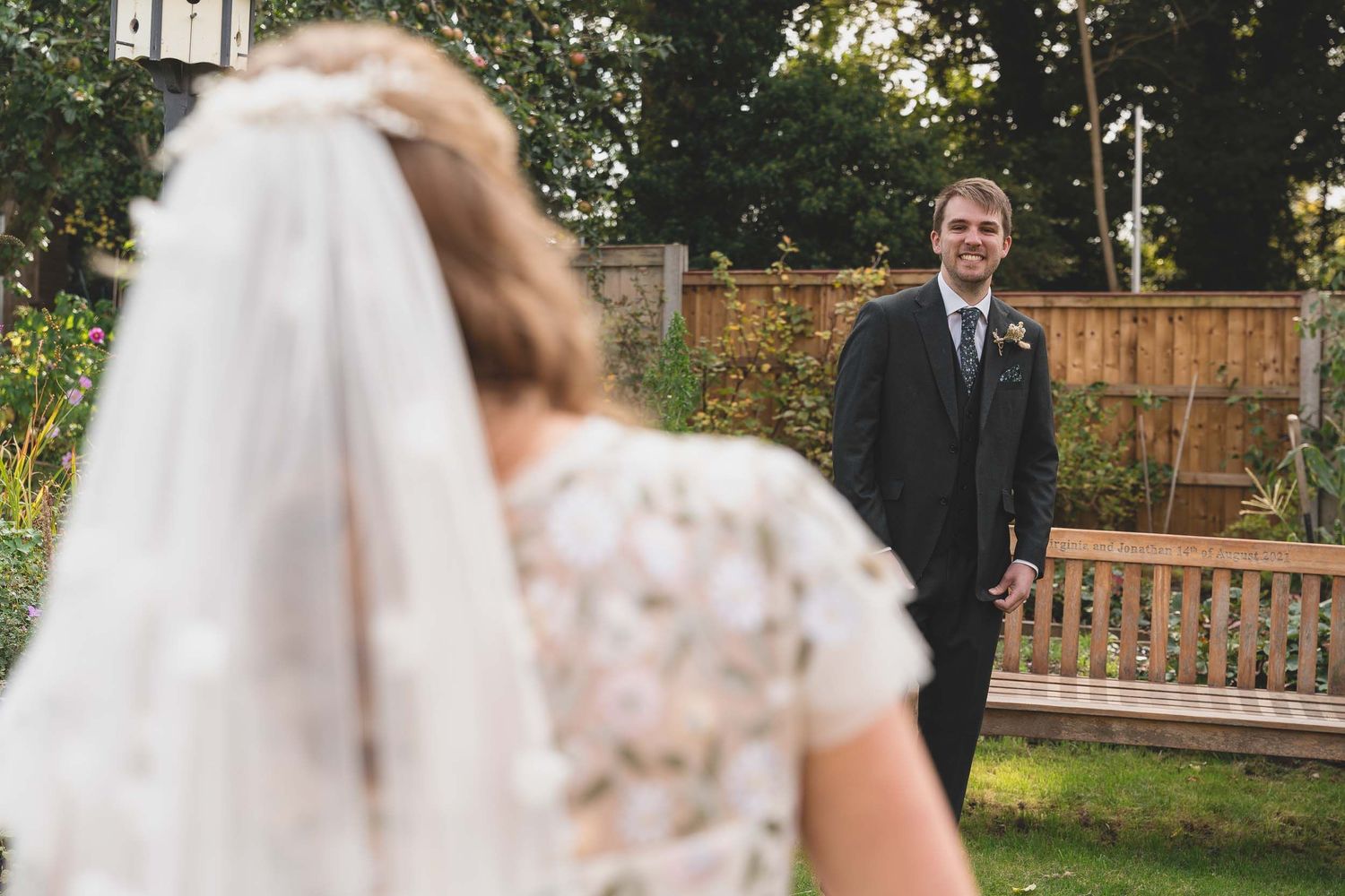 a groom smiles seeing his bride for the first time in lancashire