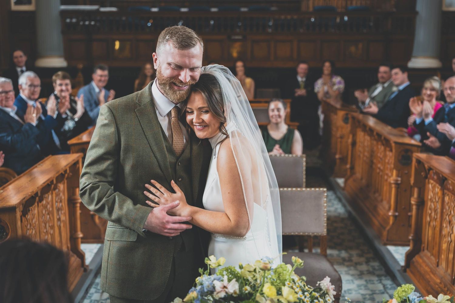 a bride and groom share an embrace during they wedding ceremony in Southport