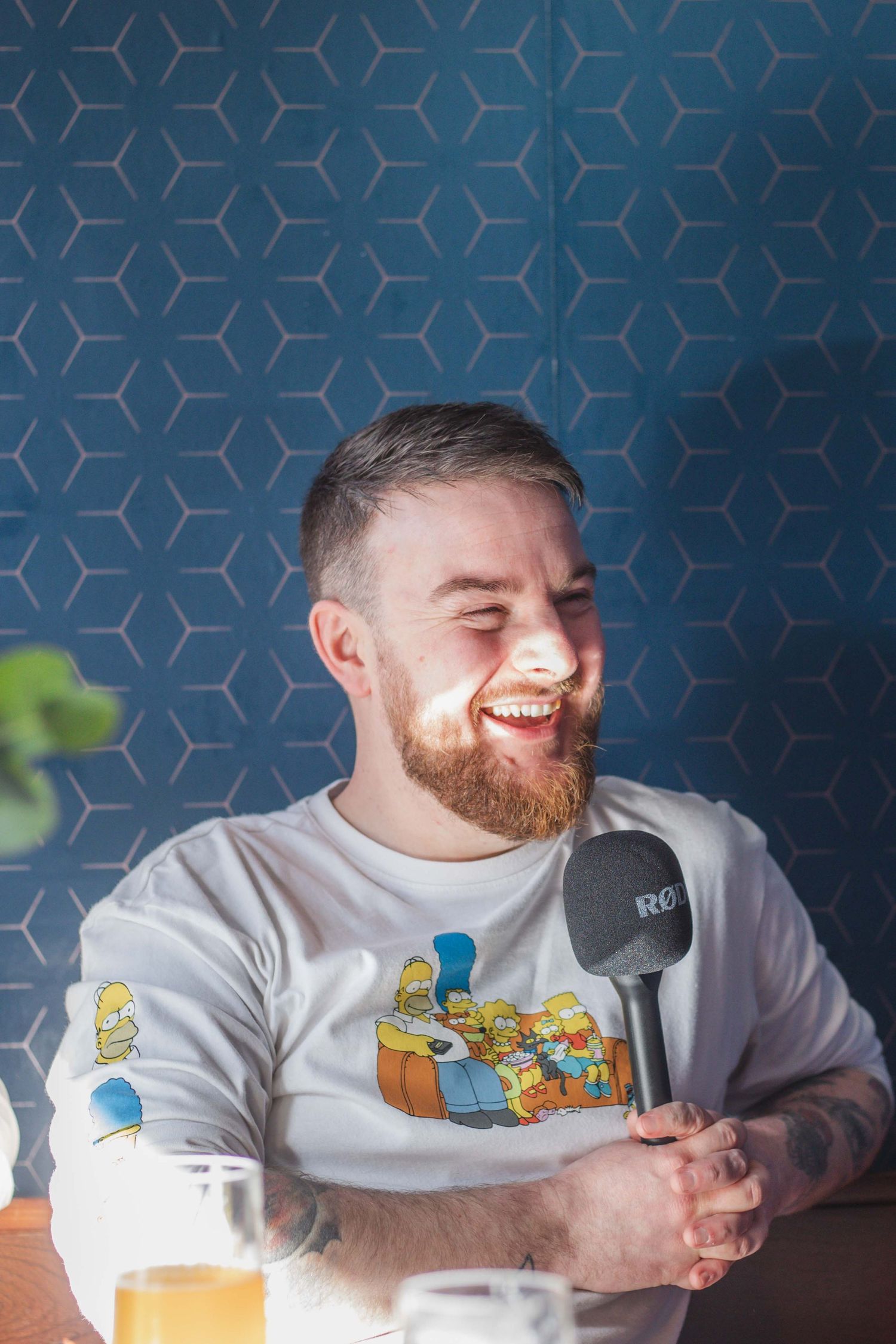 A wedding photographer laughing while holding a microphone in Preston