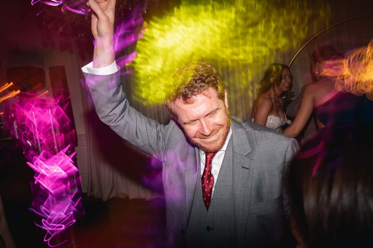 a wedding guest dances with lights shining brightly in the ribble valley