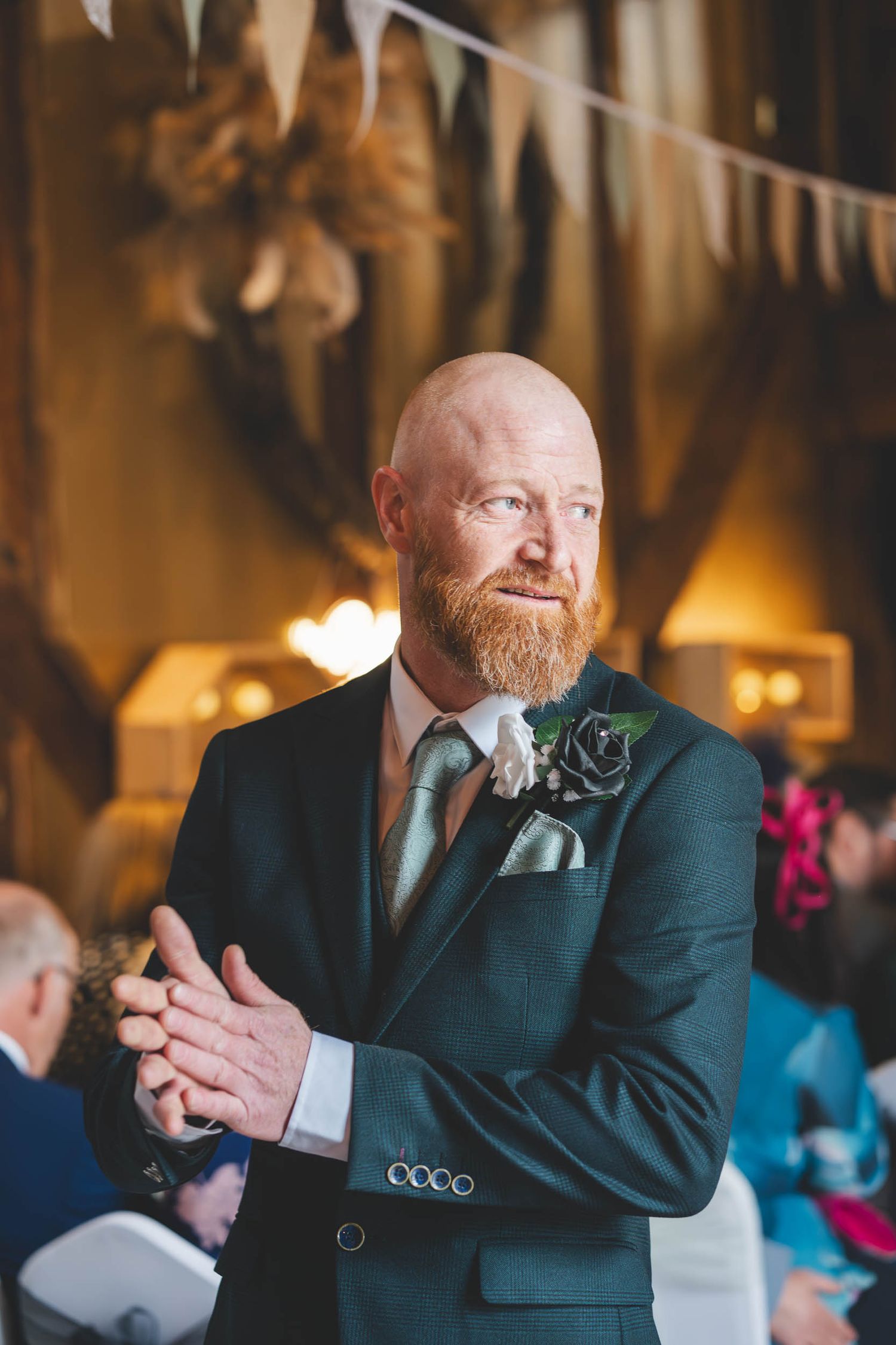 a groom nervously looks out of a window in Telford