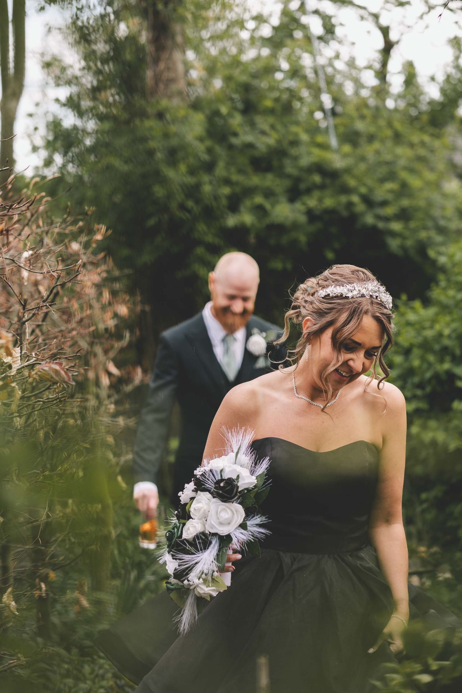 a bride and groom walk naturally through the gardens of hundred house wedding venue in telford