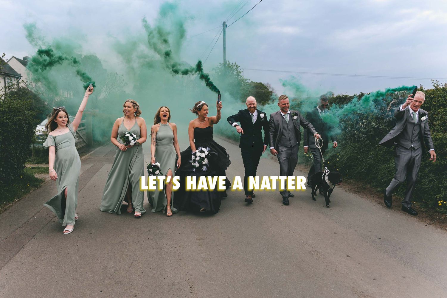 a bride, groom and their wedding party walking with smoke bombs in Telford