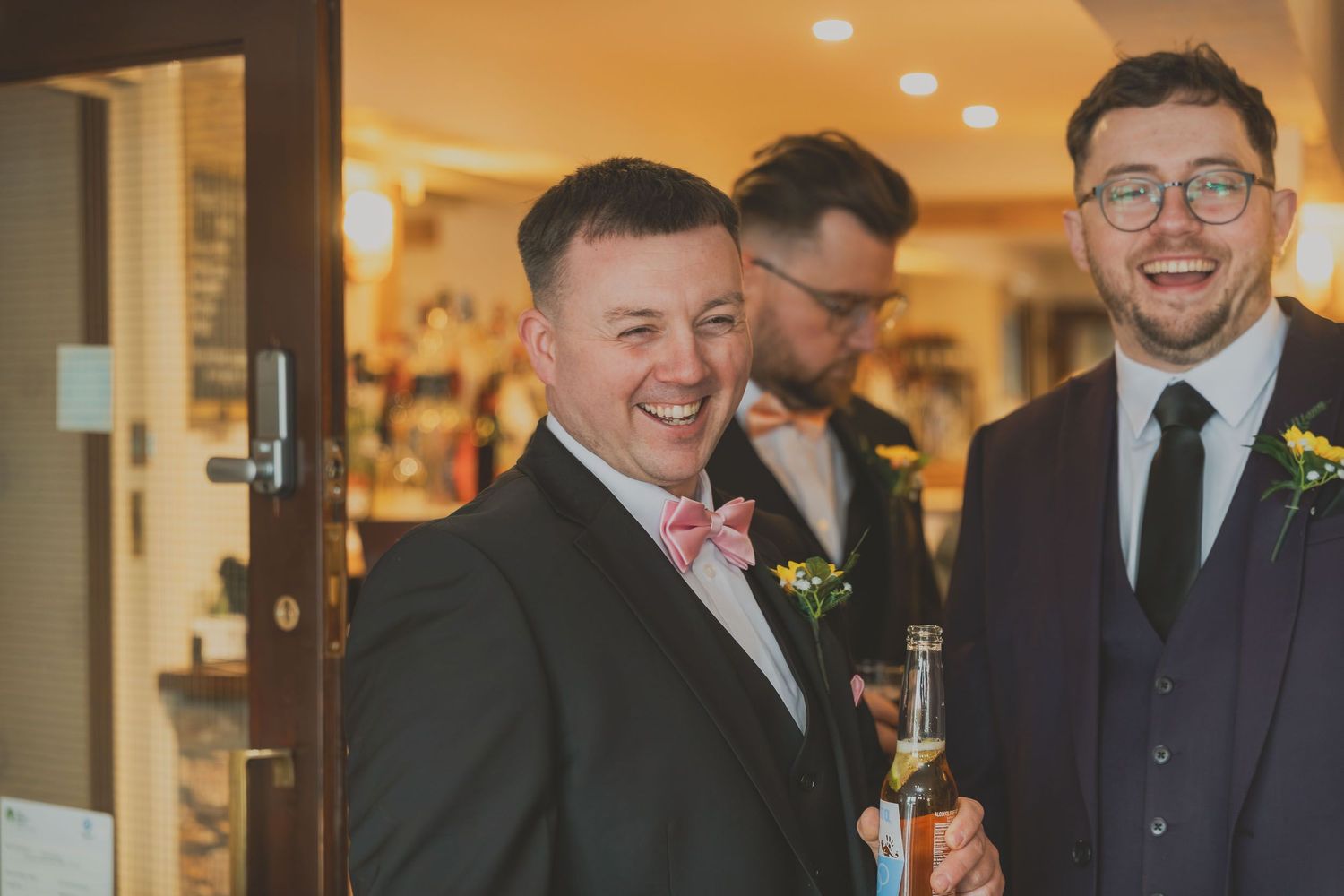 groomsmen laughing naturally at a wedding reception at Grains Bar wedding venue near Oldham