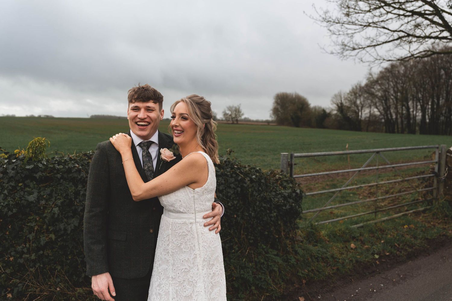 a bridge and groom smile naturally at their wedding in the cotswolds