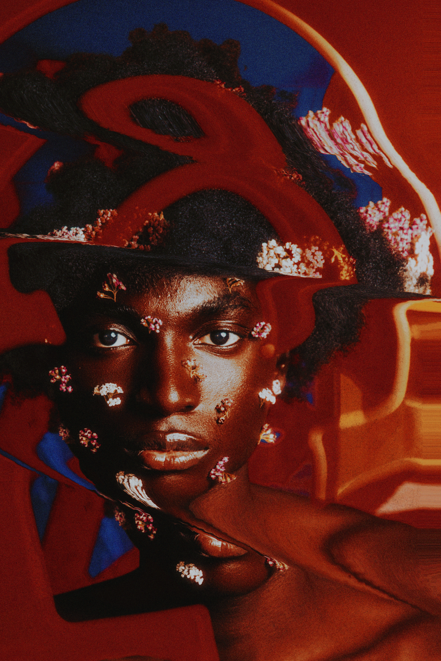 Portrait of a Black model with flowers on face and hat against vibrant red abstract background.