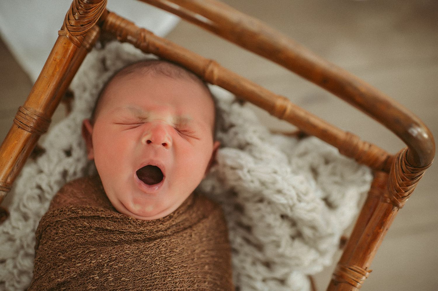 Baby boy yawning during his newborn session at a local studio in Chesapeake, VA.
