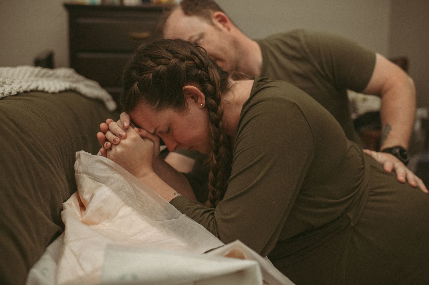 Chespeake, Virginia mom breathing through an intense contractions in her bedroom.