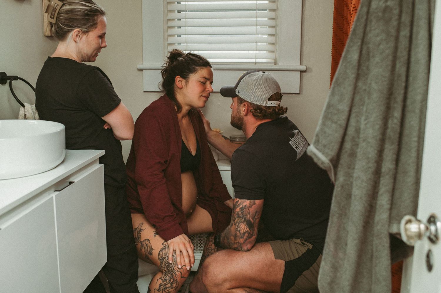 A laboring mom being supported by her husband and doula in her Norfolk, Virginia home.