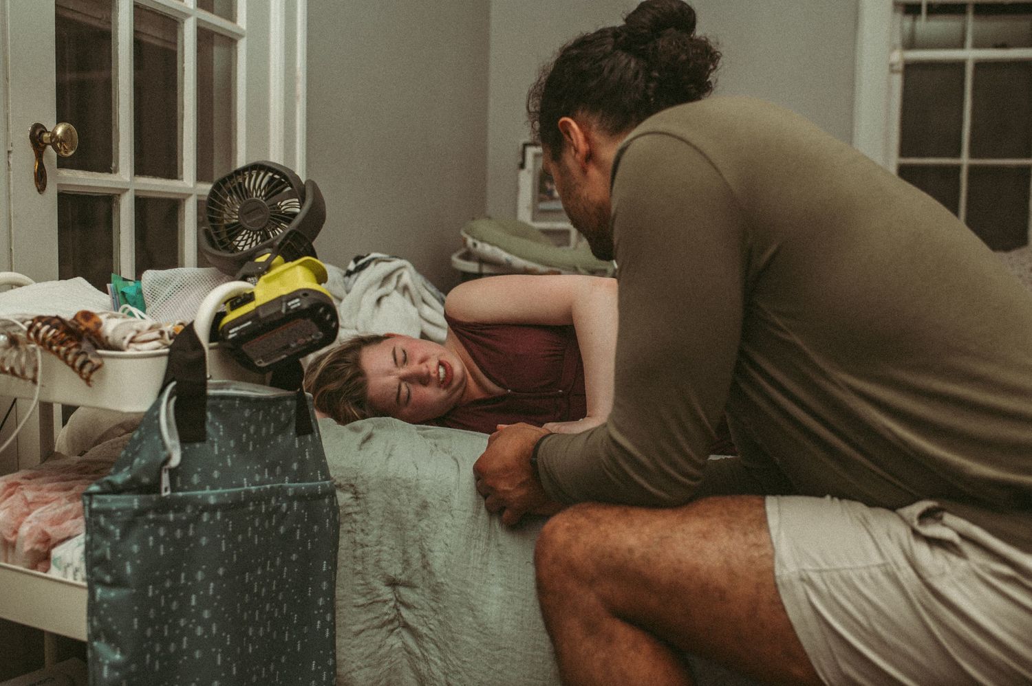Expecting Hampton Roads parents sharing a calm moment in their home while there is a break of having a contraction.