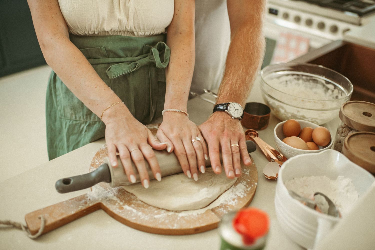 Virginia Beach expecting parents prepping pizza dough during a maternity session in Virginia.