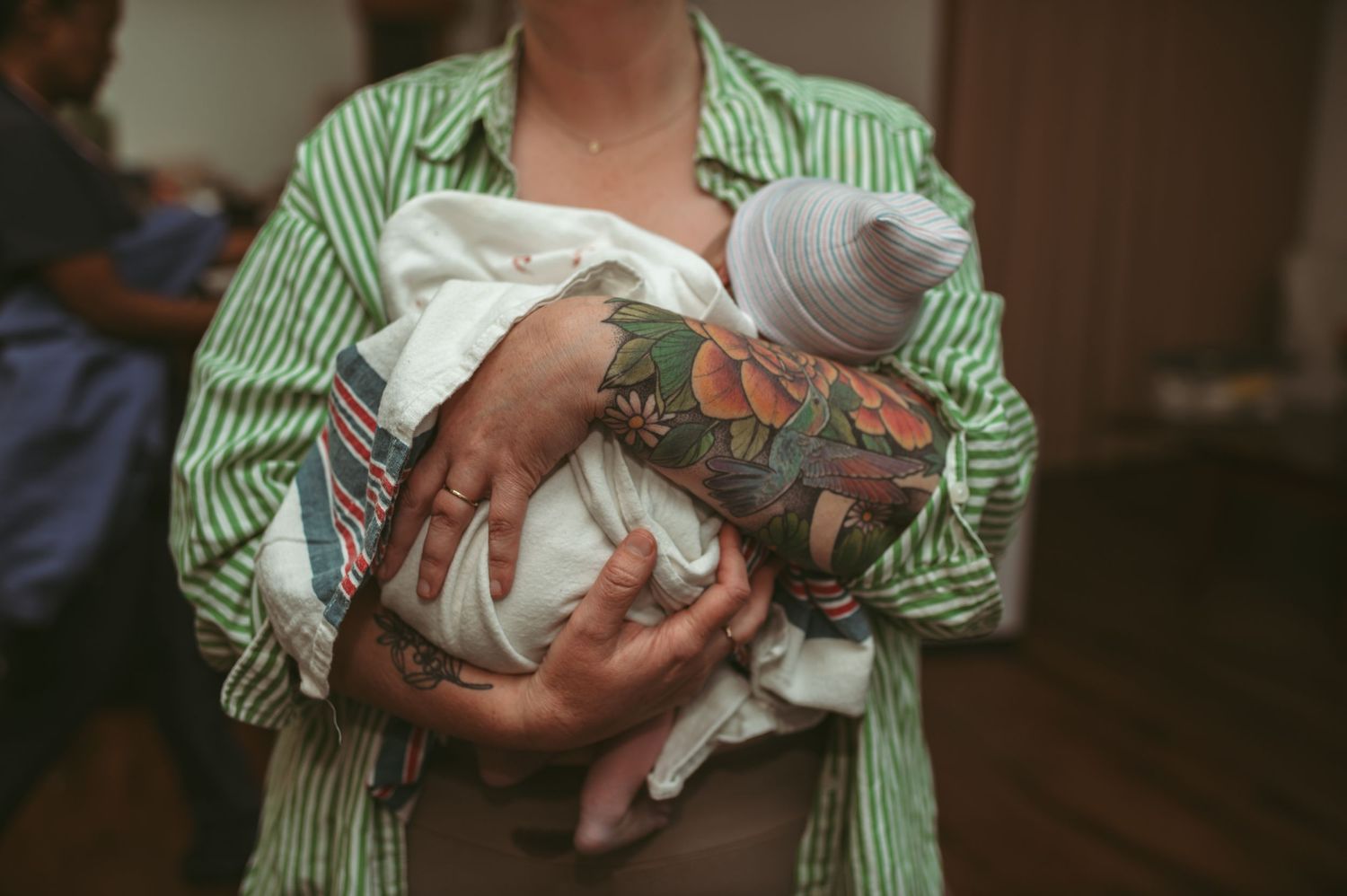 the expecting sister holding her brand new baby after her surrogate sister birthed him at her home in Newport News, Virginia.