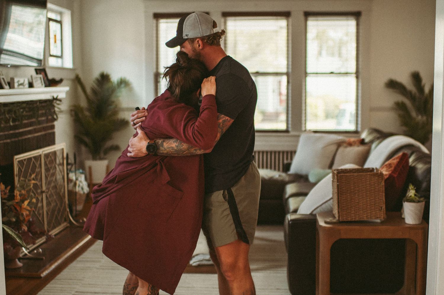 Expecting couple sway back and fourth in the living room of their beautiful Norfolk, Virginia home.