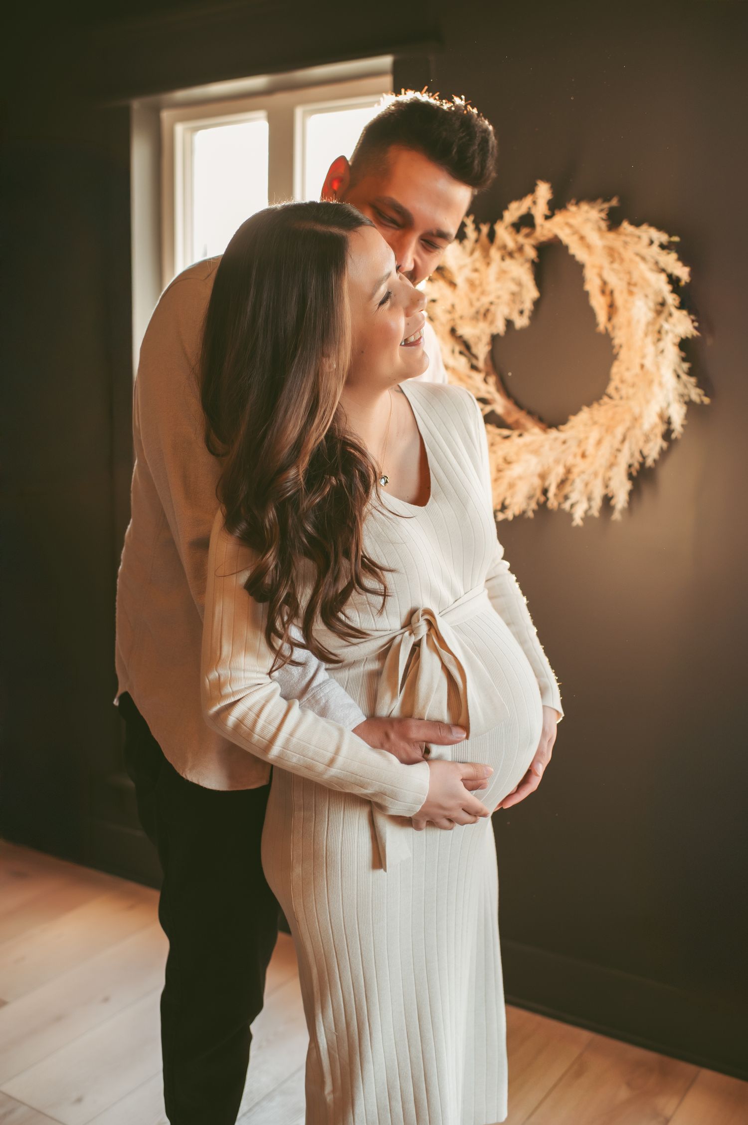 Expecting couple enjoying a sweet moment together during their maternity photo session in Chesapeake, Virginia.