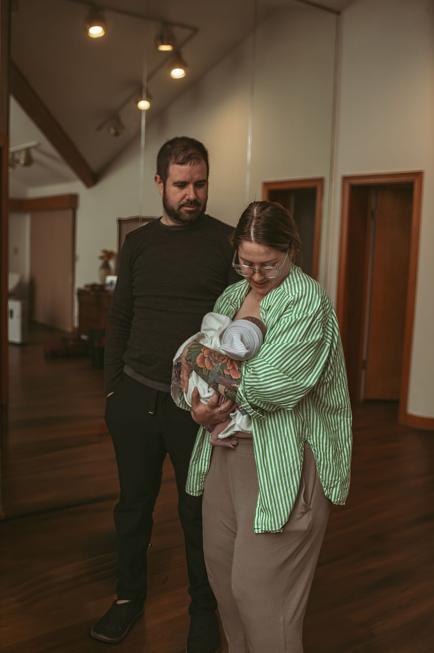 Brand new parents soaking up their brand new baby boy after mom's sister gave birth to him in her home in Newport News, Virginia.