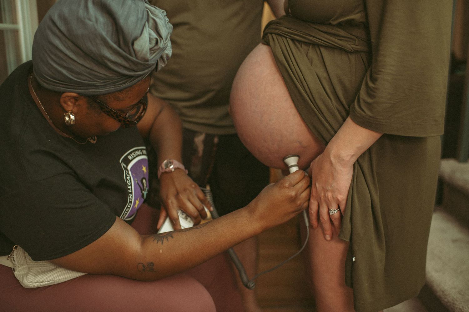 Virginia student midwife checks baby's heart rate in between contractions.