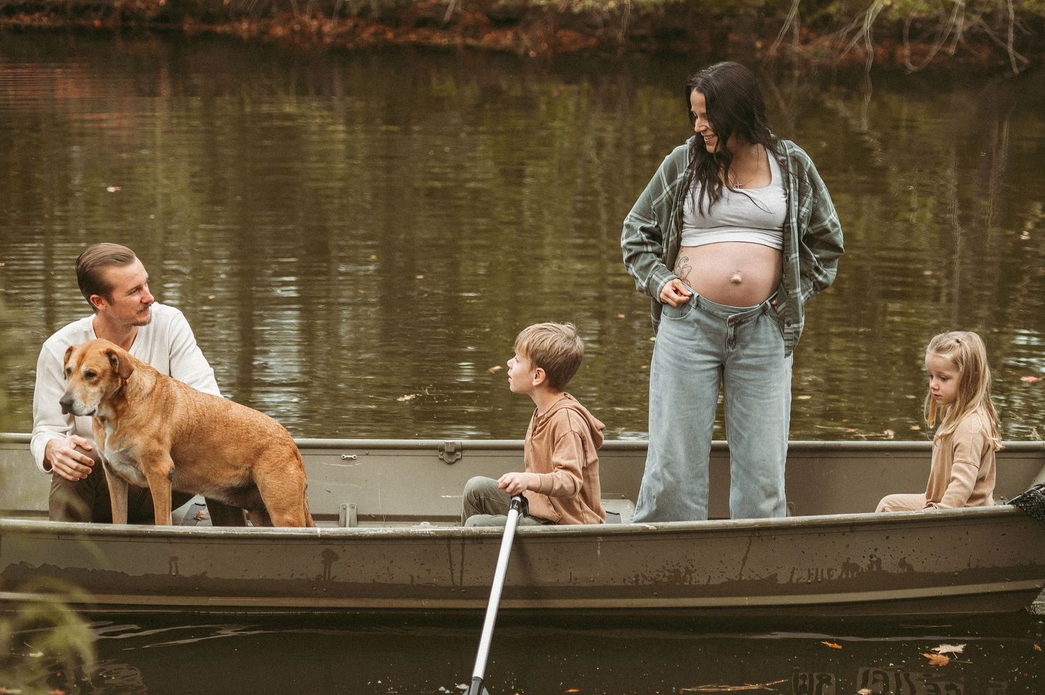 A family portrait of a Chesapeake, Virginia family in their personal boat in their backyard.