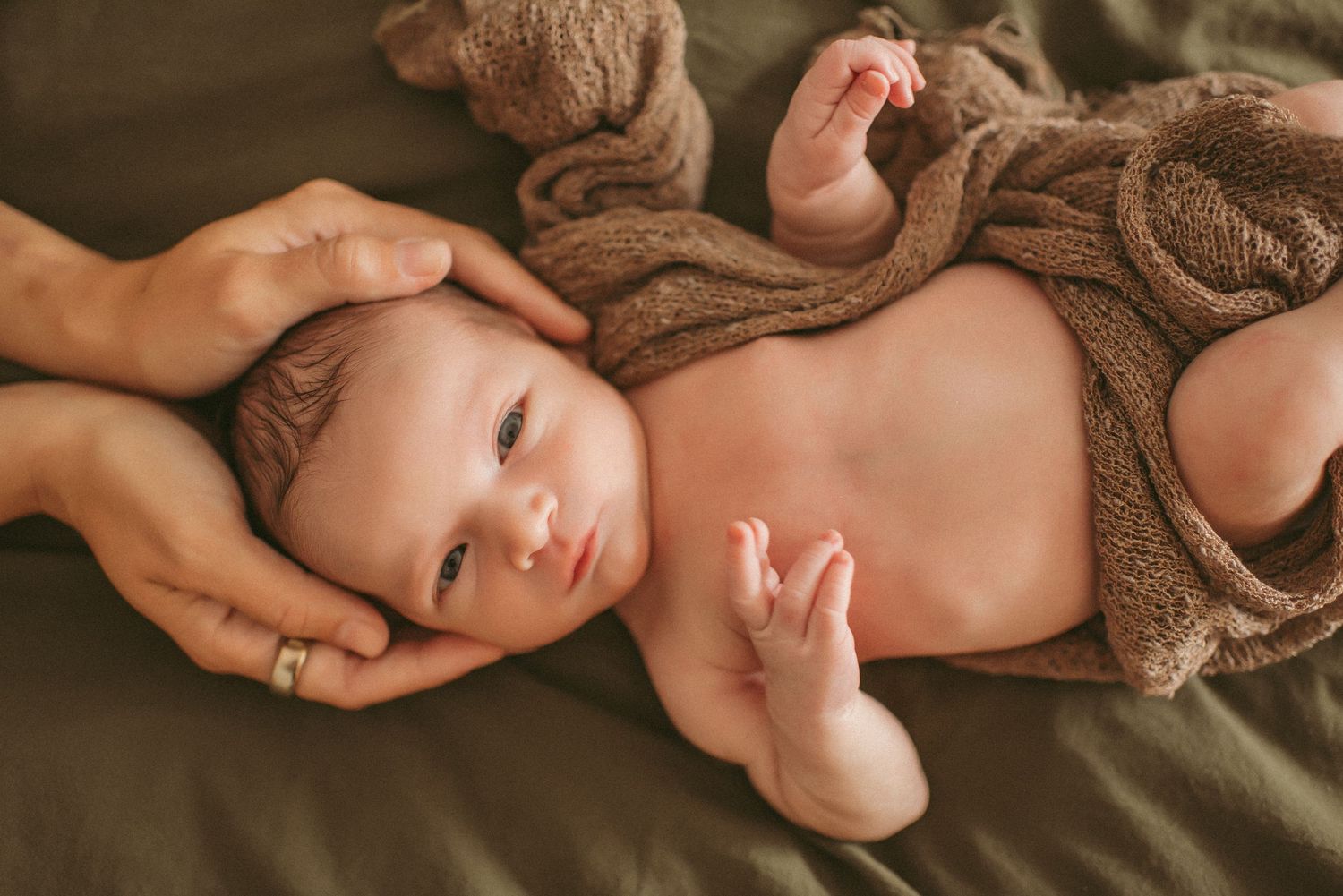 Newborn boy posing in a Newport News home for a in home newborn session.