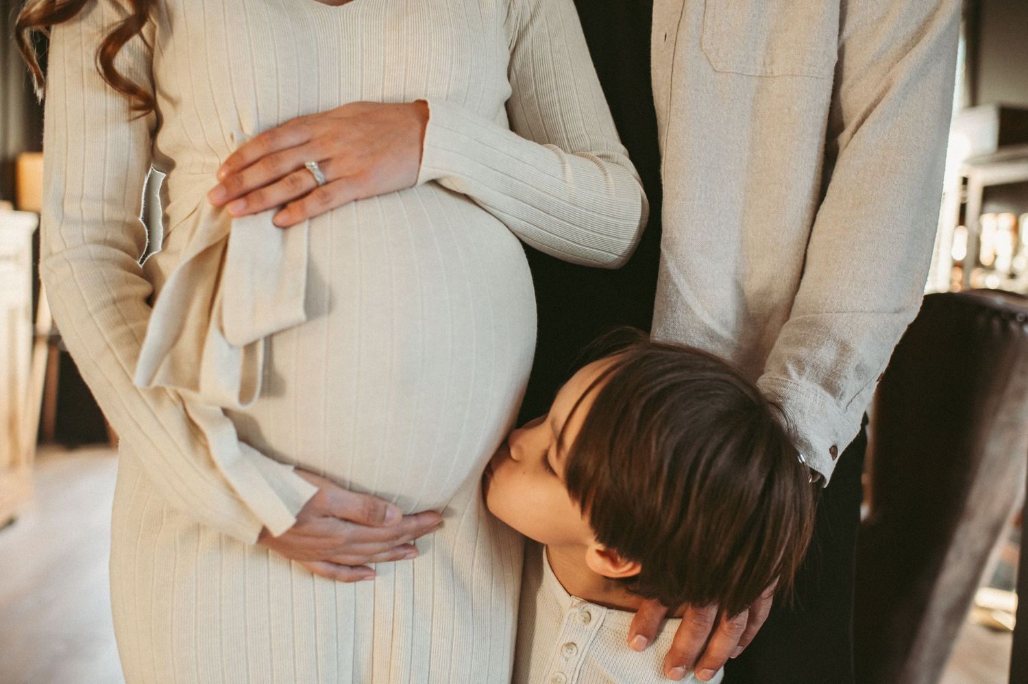 Big brother sharing a kiss to his new sibling at a maternity session in Chesapeake, VA.
