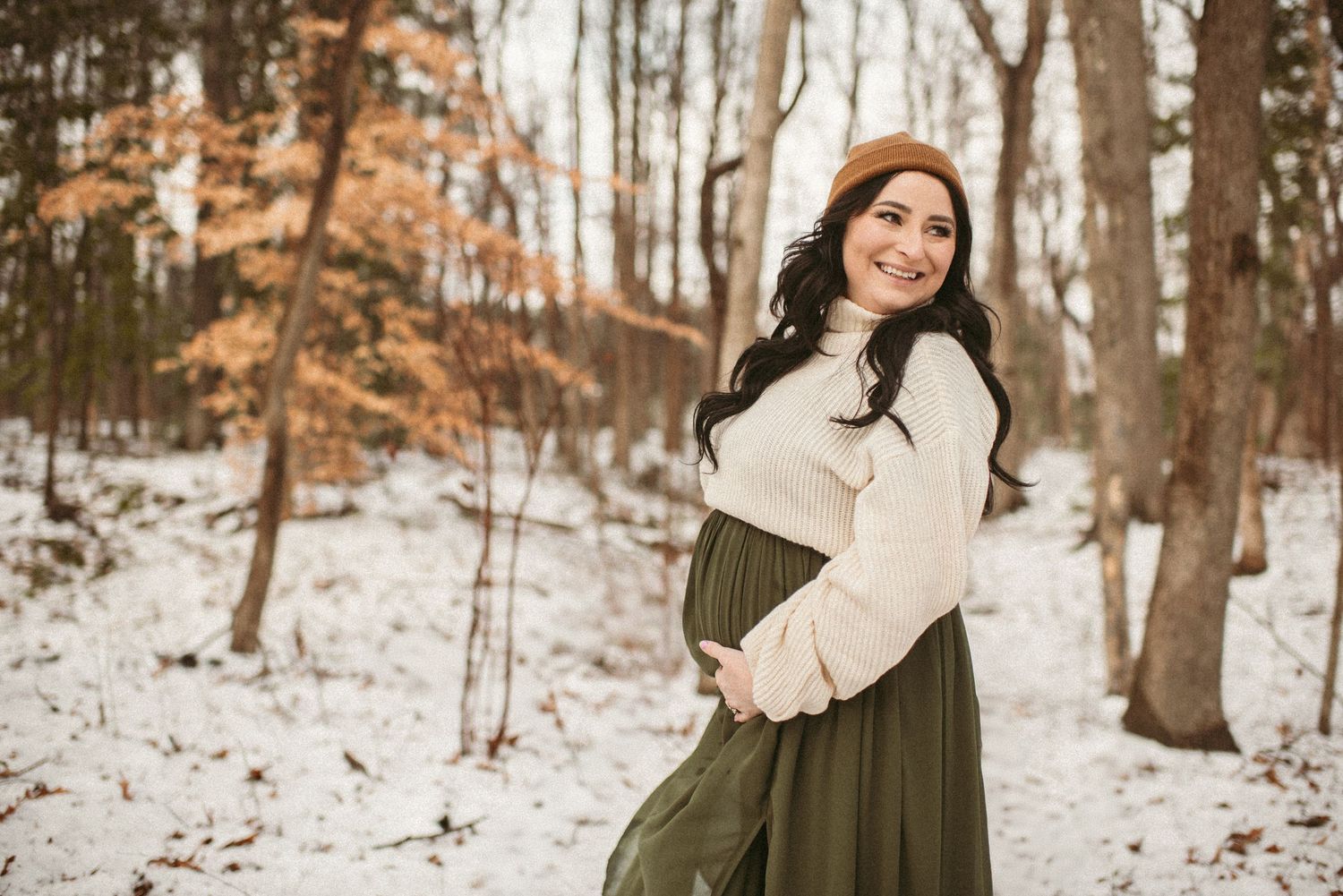 Expecting mother posing in the snow in Suffolk, Virginia during her maternity session.