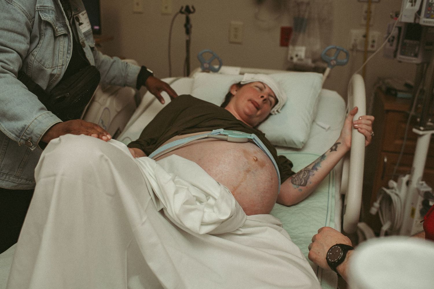 Expecting mom labors in hospital bed in Norfolk, Virginia.