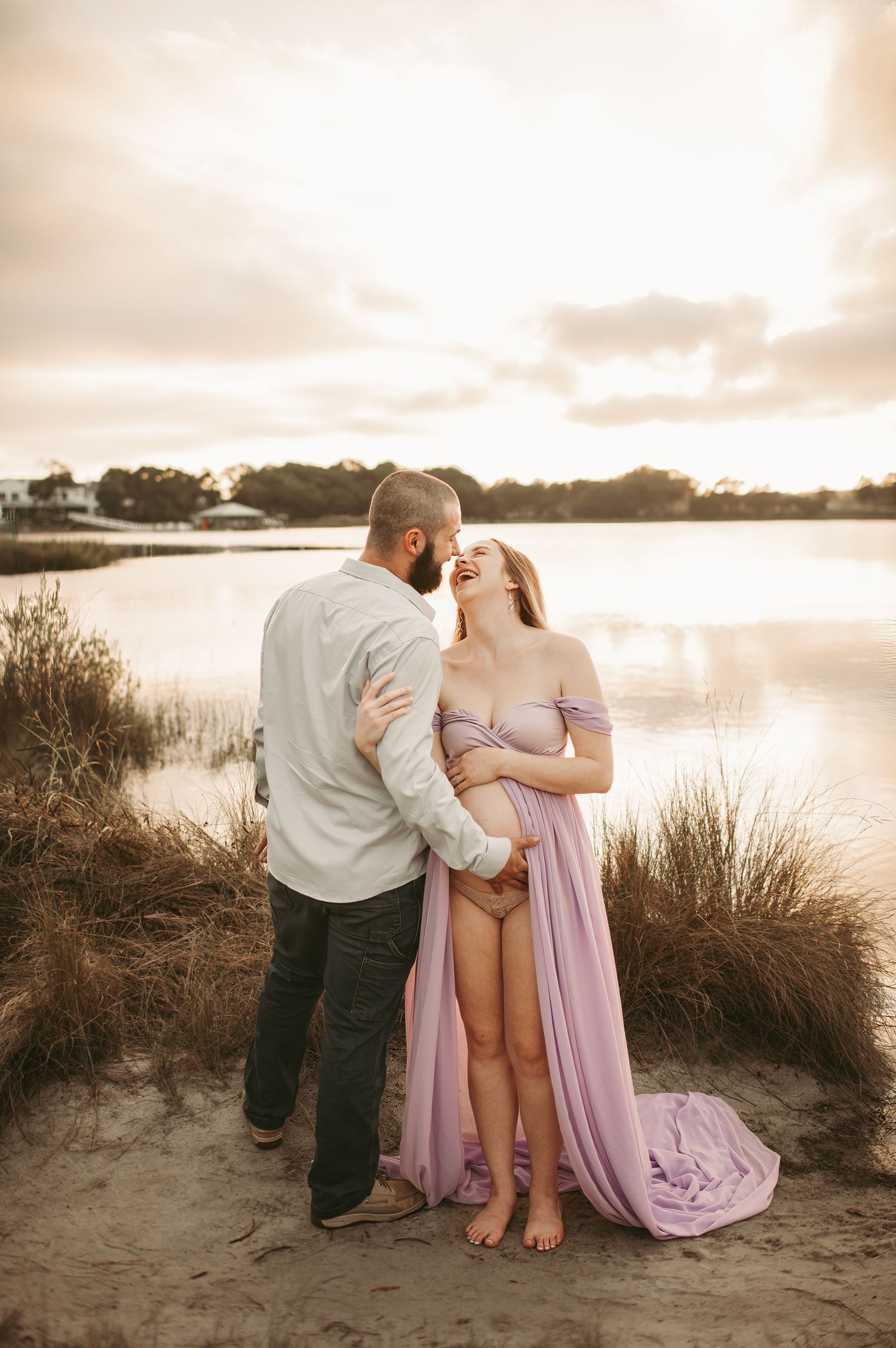 Virginia Beach expecting couple having a small laugh during their maternity session at the Environmental Brock Center.