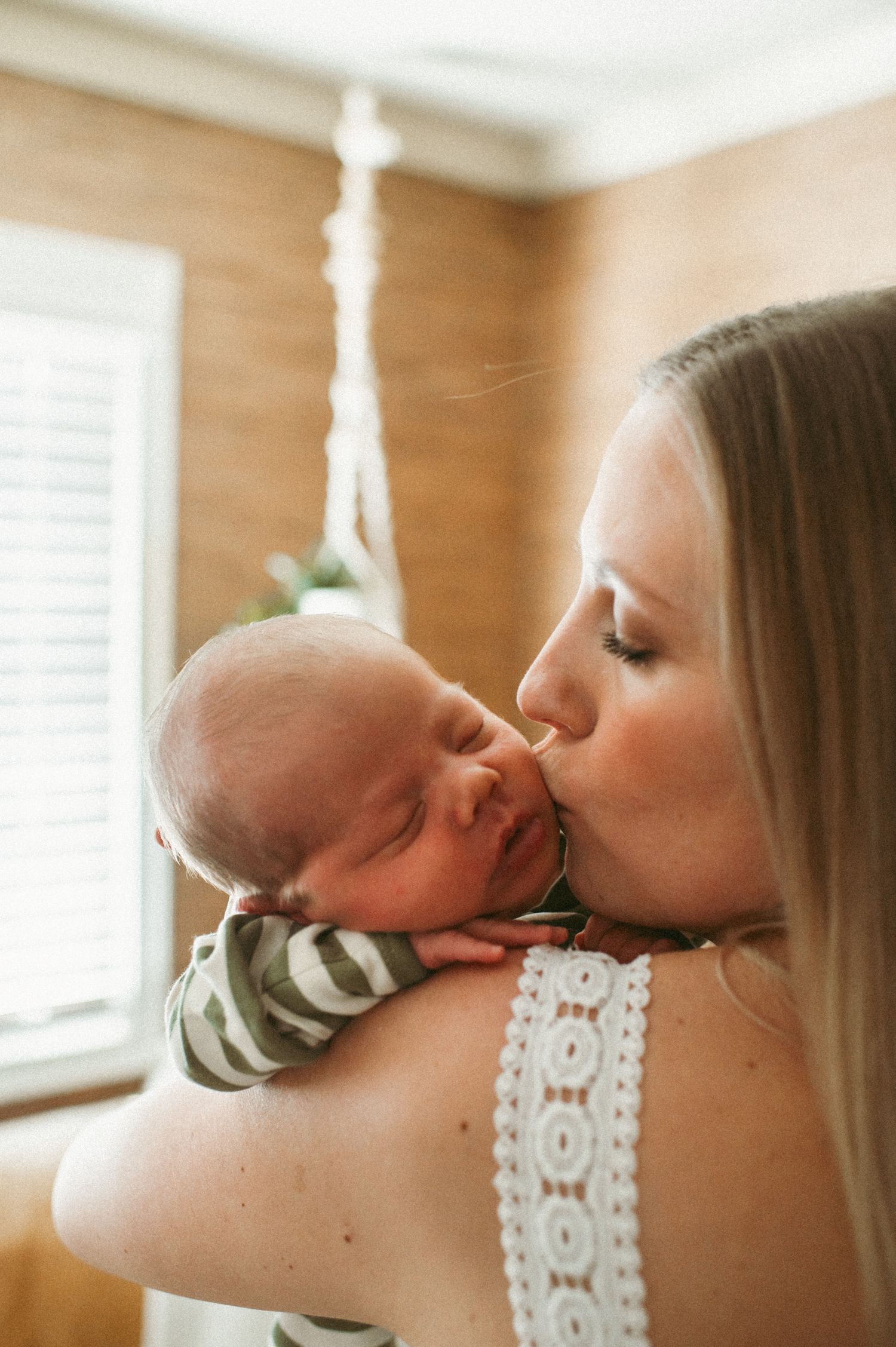Chesapeake, Virginia mom gentle kissing her newborn baby boy during their newborn session.
