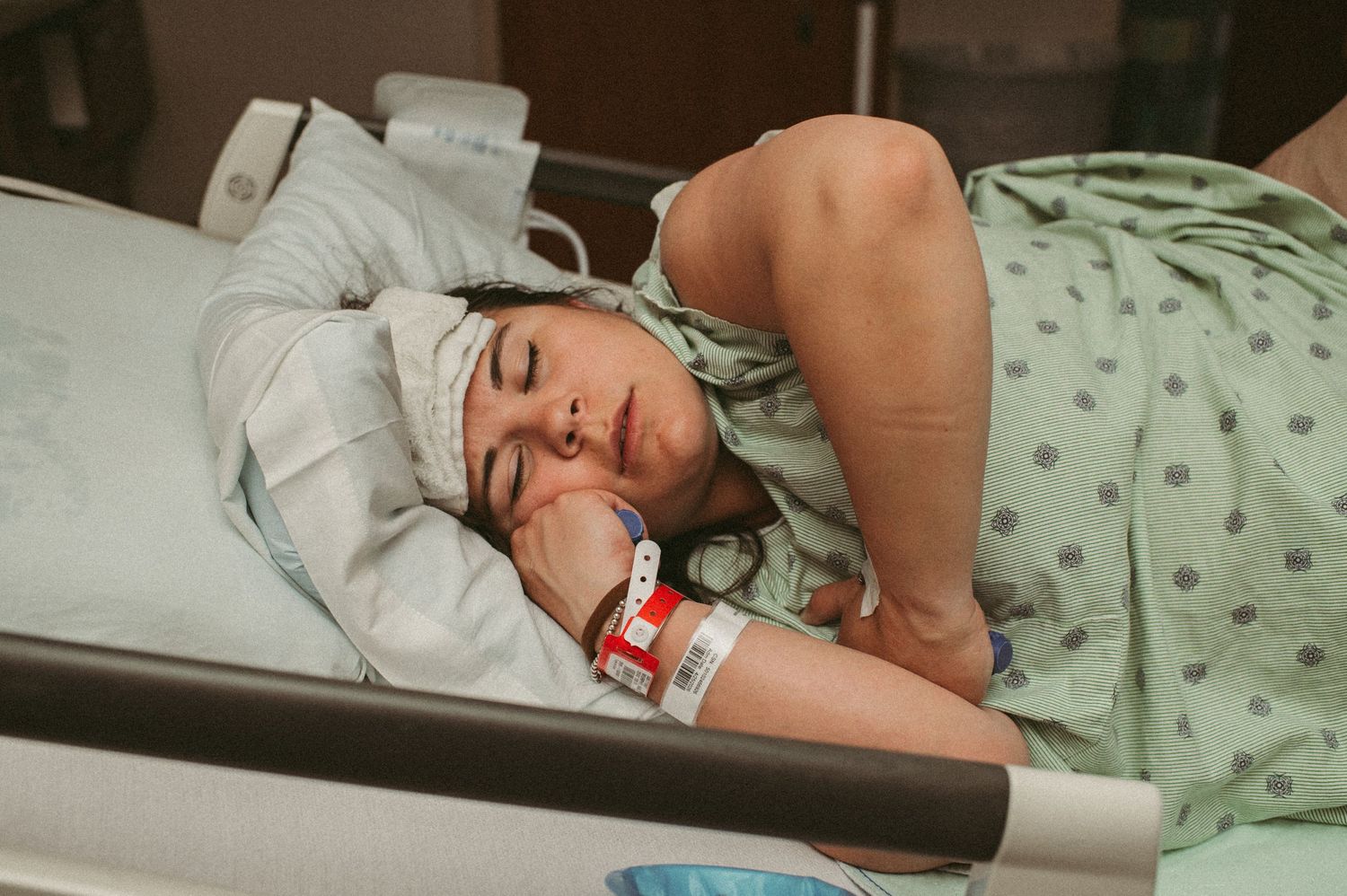 Laboring mother laying in Virginia hospital bed taking a rest between contractions.
