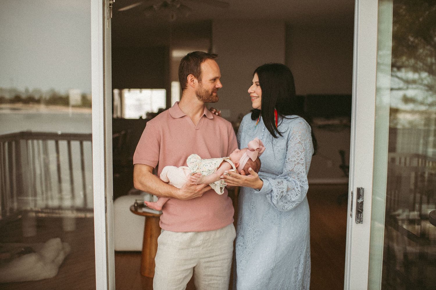 New parents looking at each other during their Lifestyle Newborn Session in their Norfolk home.
