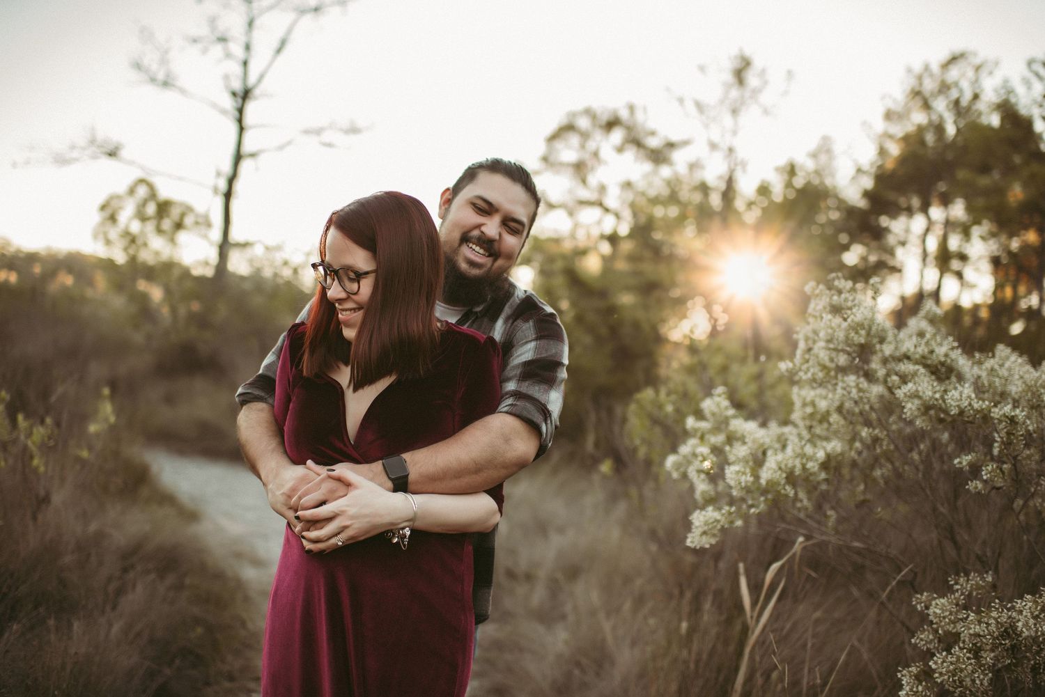 Expecting couple sharing a laugh during a maternity session in Virginia Beach, Virginia.