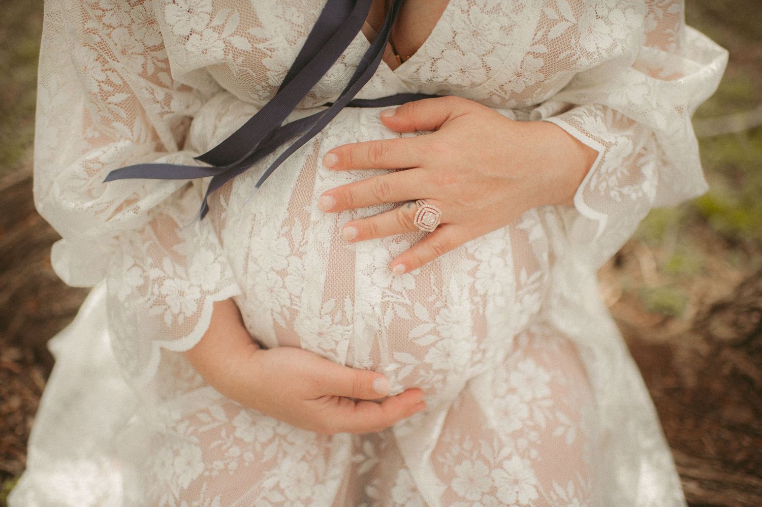 Expecting mom holding her round belly in Gloucester, Virginia.