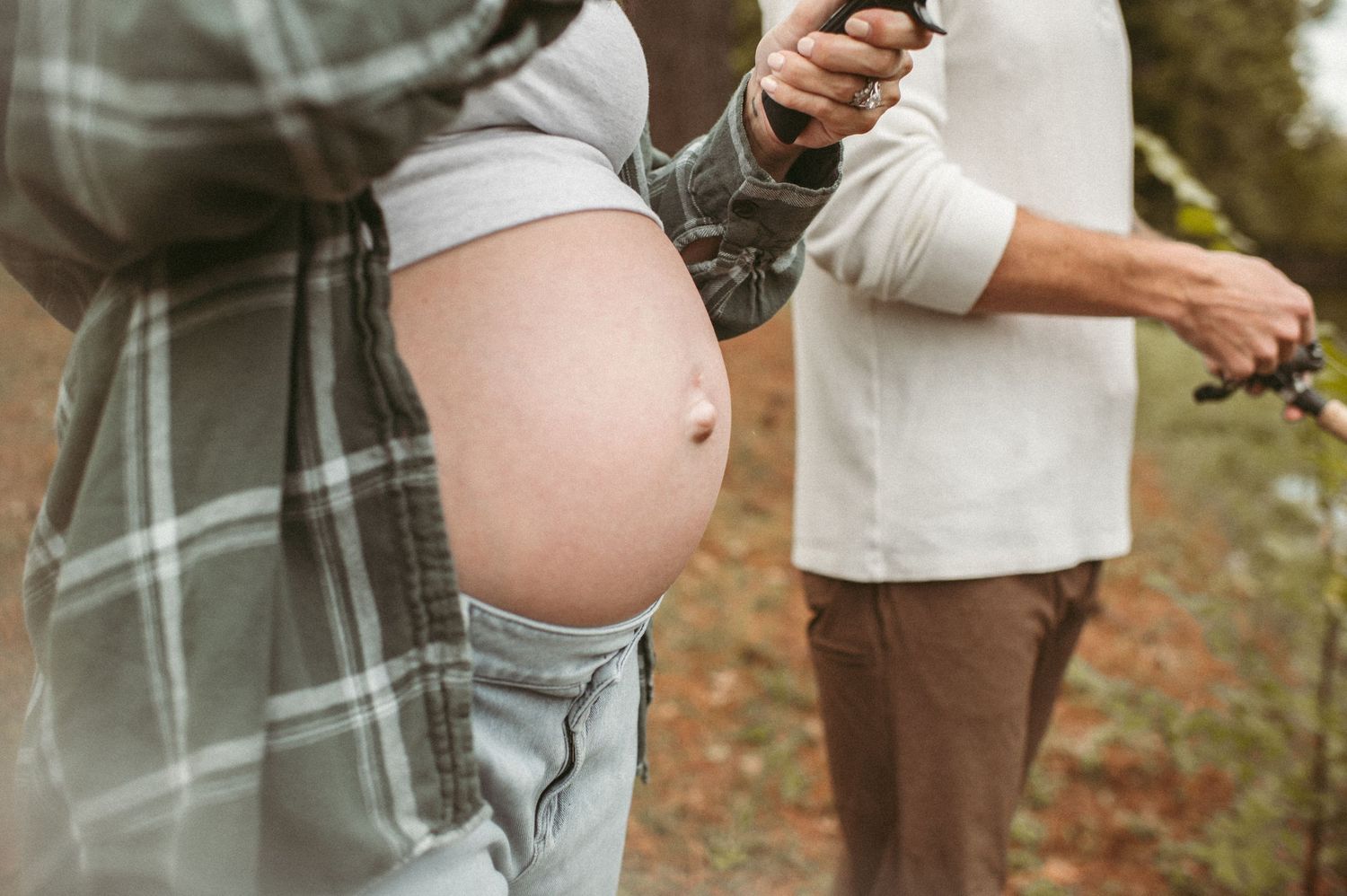 Baby bump photo of an expecting mom while she fishes in her backyard in Chesapeake, Virginia.