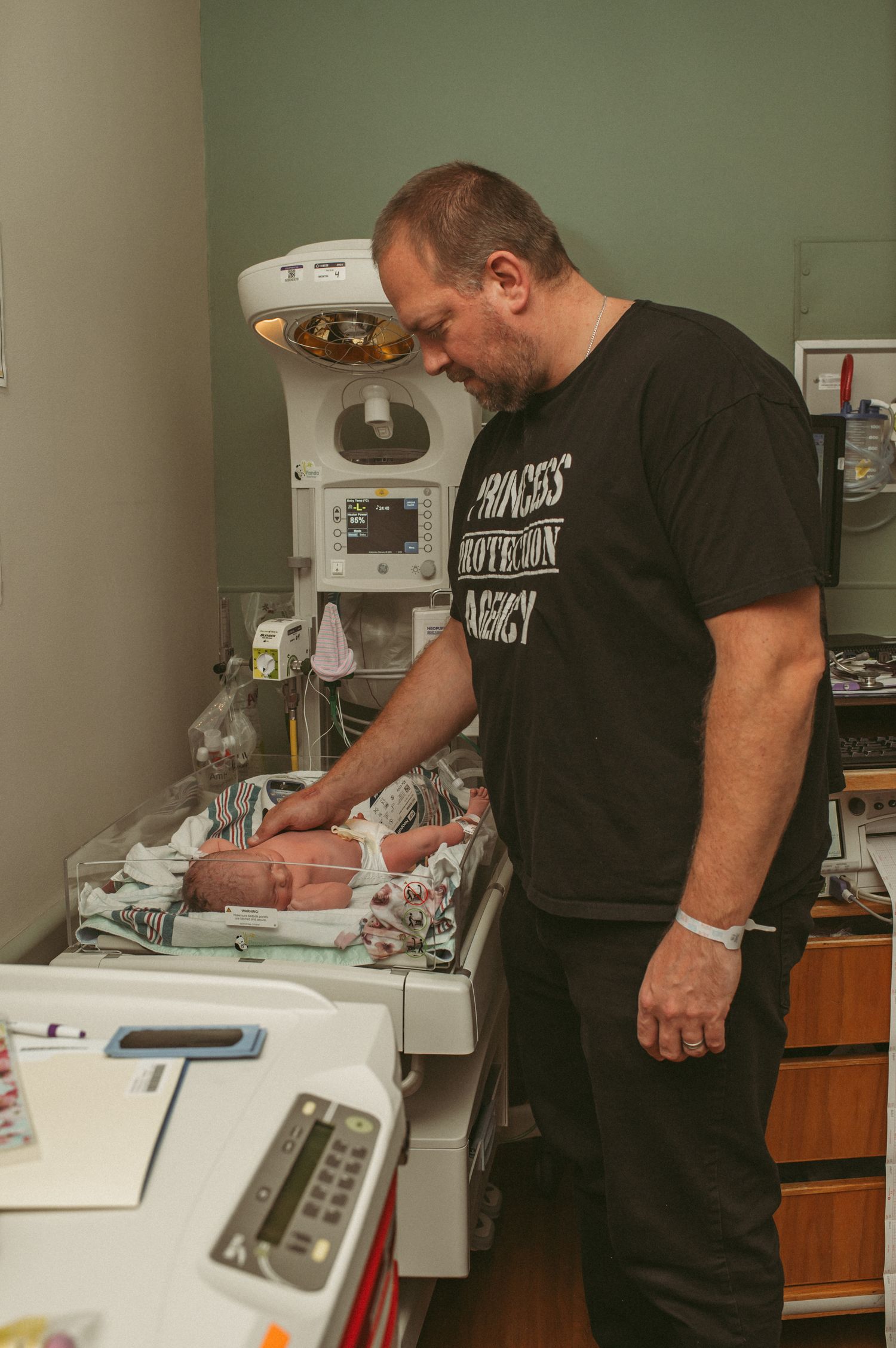 Suffolk, Virginia dad stands beside his brand new baby girl while the hospital staff at Sentara Leigh make sure that mom is good to go.