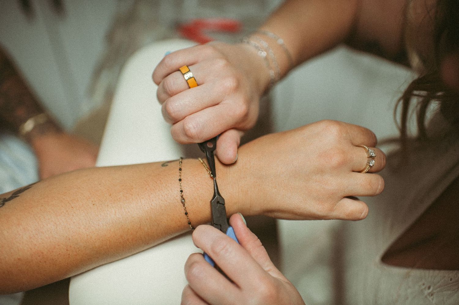 a close up of a permanent jewelry business putting on a bracelet during a branding photo session in Virginia Beach.