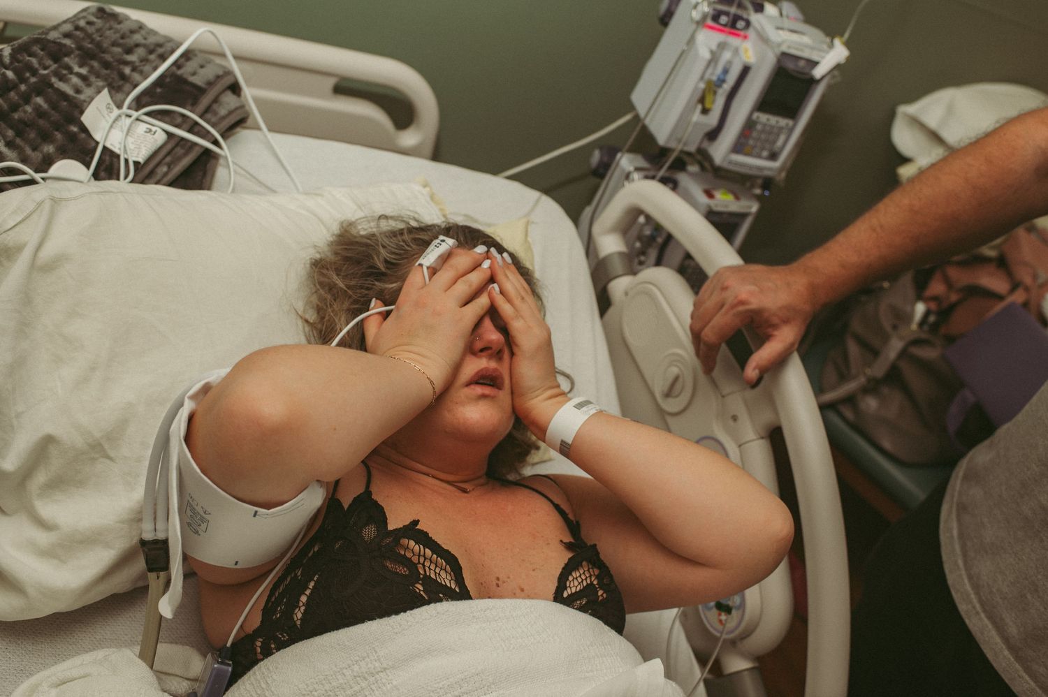 Suffolk mom taking a moment to take deep breaths in a Virginia Beach hospital while having contractions.