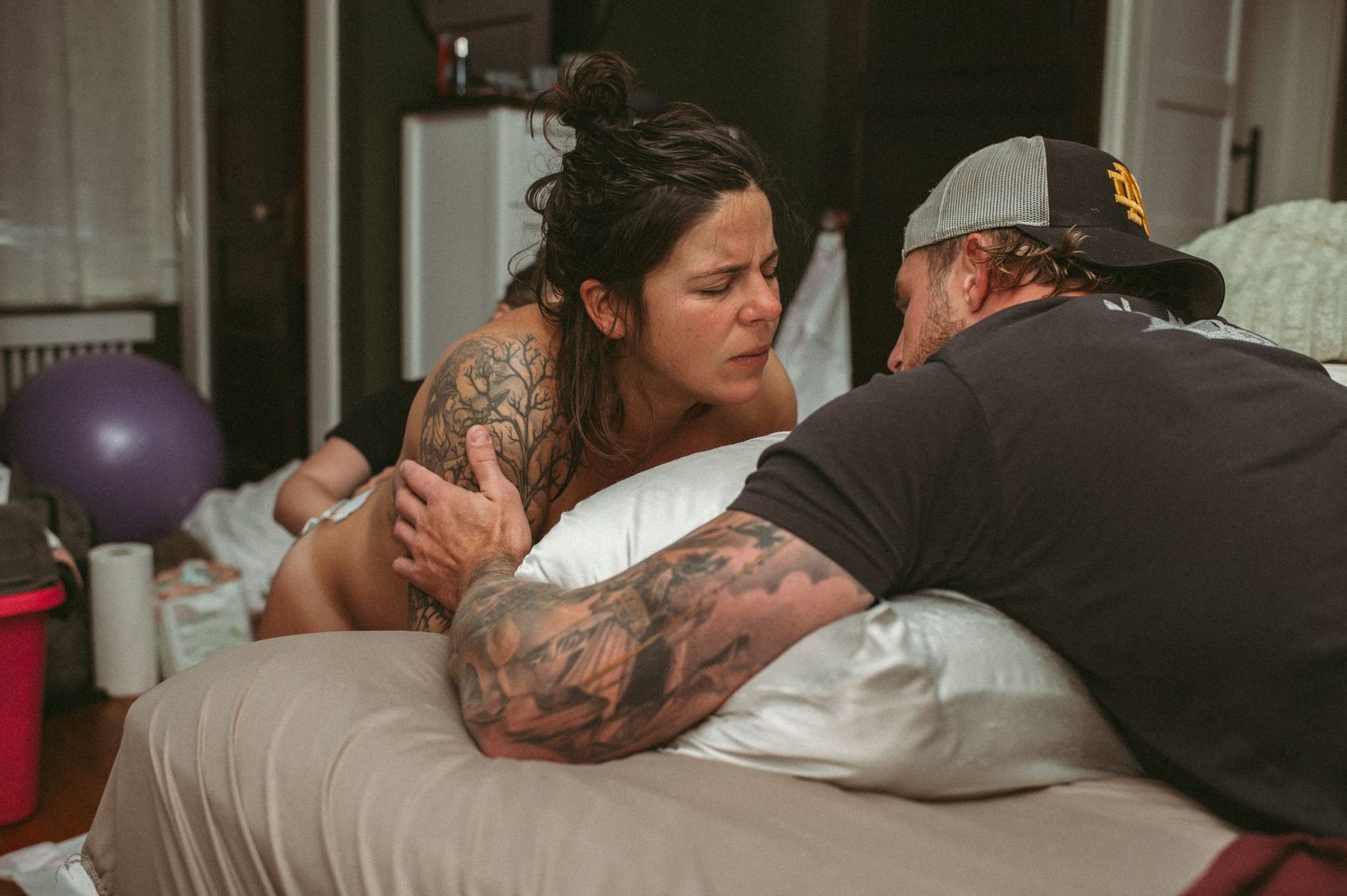 Norfolk expecting mom being supported by her husband while having a strong contraction.