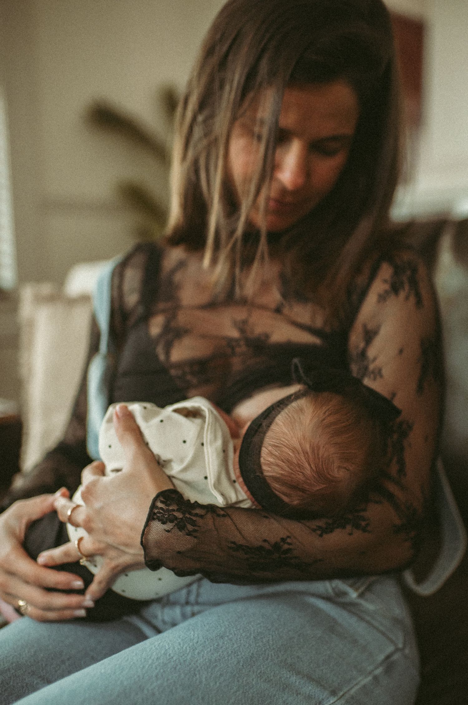 Norfolk, Virginia postpartum mom nurses brand new baby girl and their newborn session.