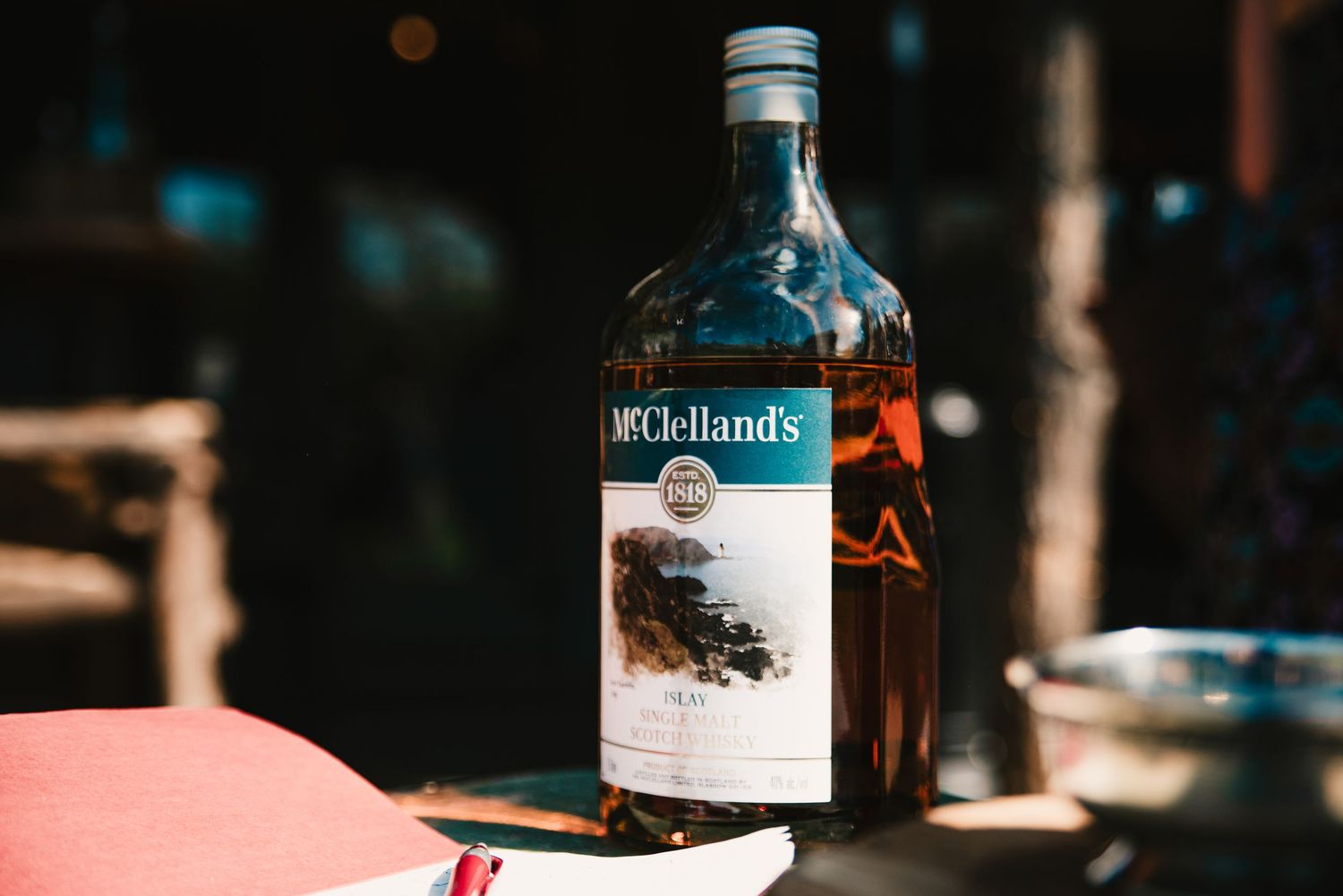Bottle of McClelland's Scotch whisky on a table at a Scottish-themed wedding celebration.
