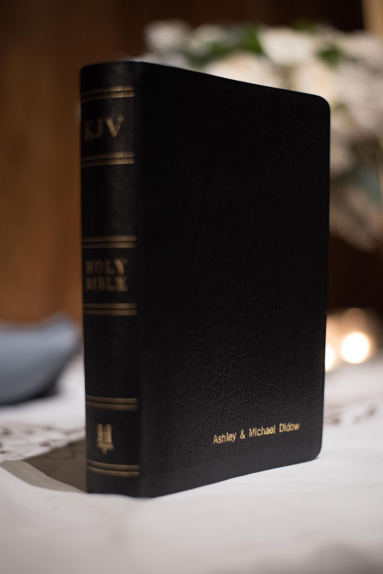 Personalized black KJV Holy Bible with gold embossed names Ashley & Michael Dickner on leather cover.