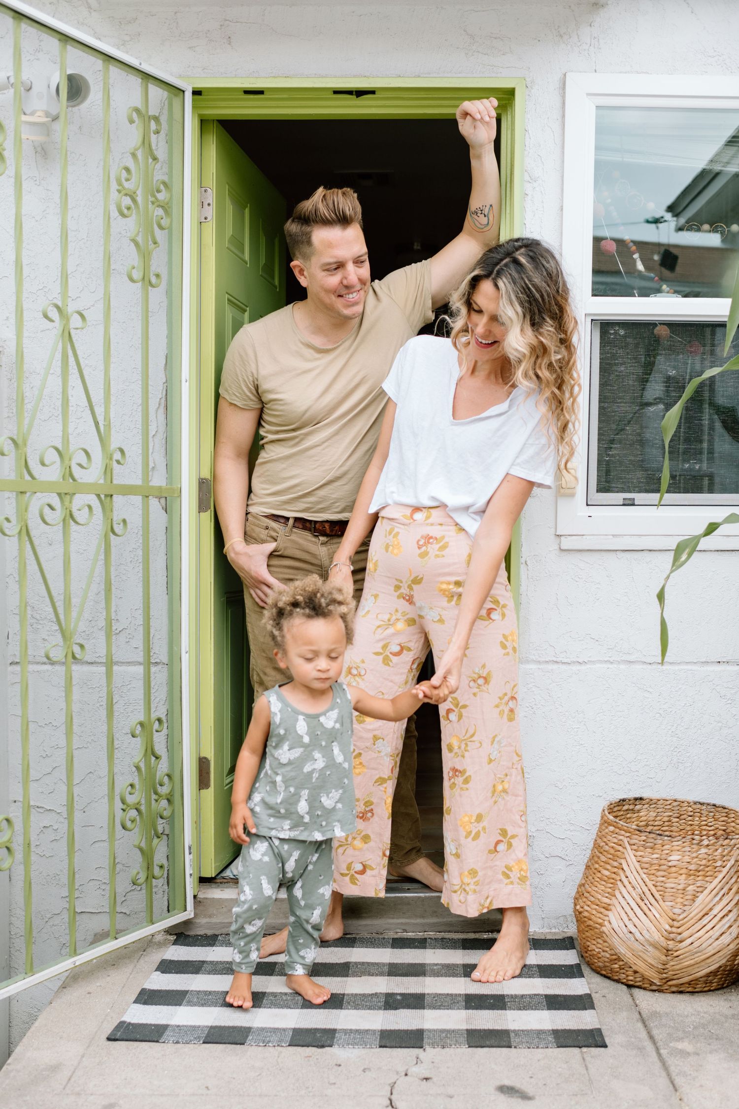 Man looks at wife during during at home family photoshoot in San Diego.
