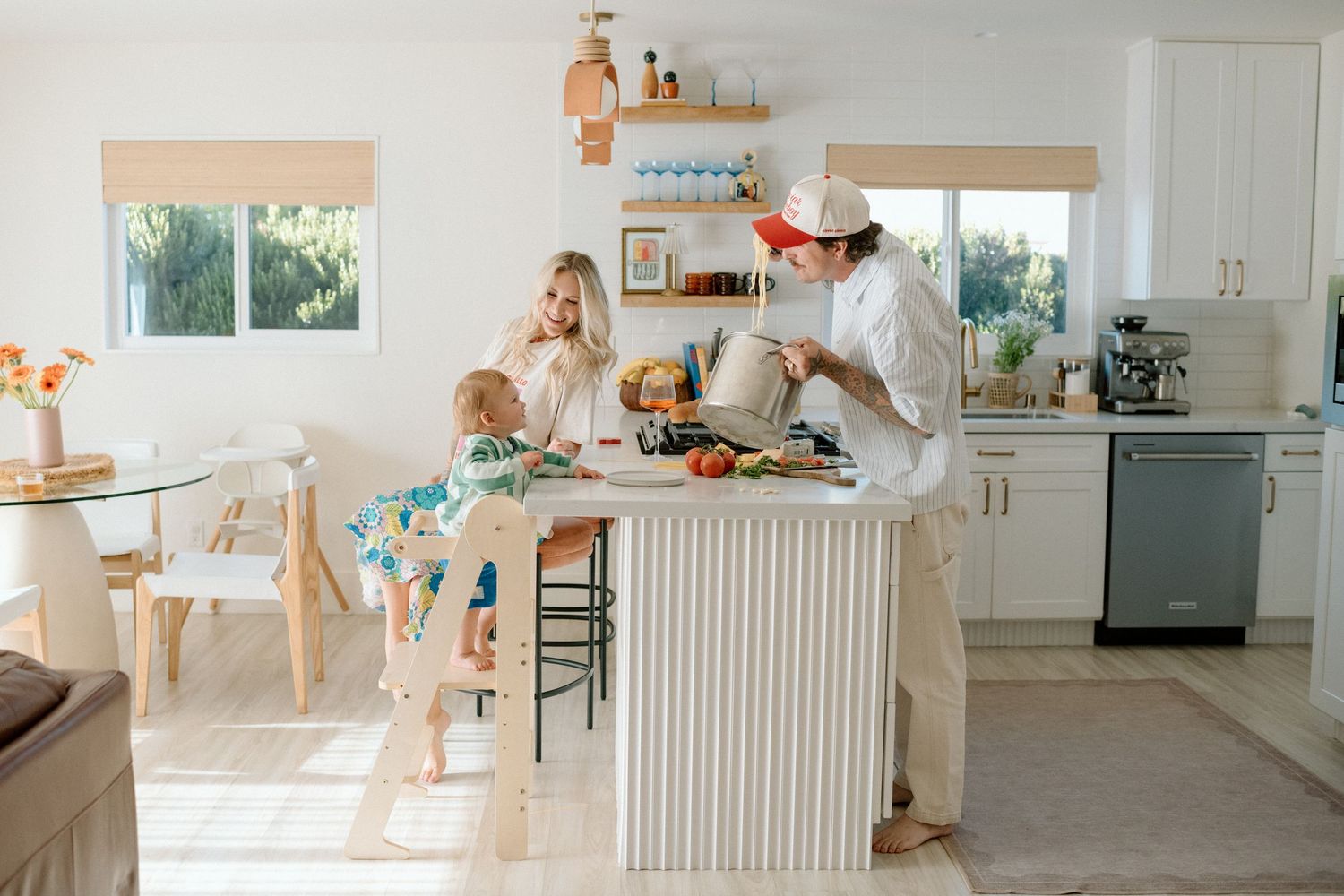 A bright, minimalist interior design series showing a modern white kitchen with various perspectives and angles.